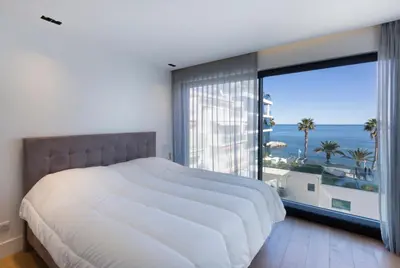 a bedroom with a large bed and a large window at Apartment Lara Light apartment with an incredible view in Cannes
