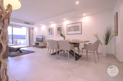 a dining room with a table and chairs at Appartement Céto Superb and luminous apartment in Cannes