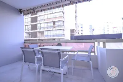 a table and chairs in a room with a window at Appartement Céto Superb and luminous apartment in Cannes