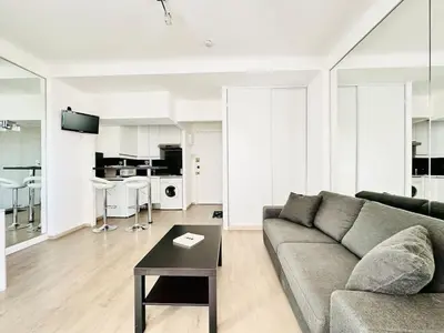 a living room with a couch and a table at Palm Croisette - Studio vue Mer & Martinez in Cannes
