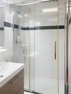 a shower with a glass door in a bathroom at Appartement L'Etang Cannes Pointe Croisette in Cannes