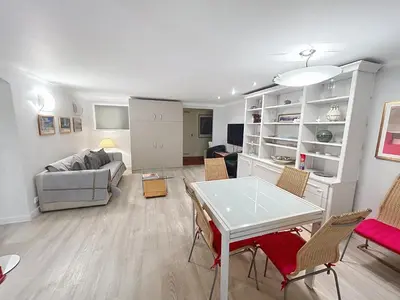 a living room with a couch and a table at Appartement L'Etang Cannes Pointe Croisette in Cannes