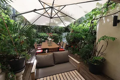 a patio with a table and chairs and plants at Appartement L'Etang Cannes Pointe Croisette in Cannes