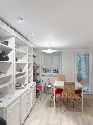 a kitchen and dining room with a table and chairs at Appartement L'Etang Cannes Pointe Croisette in Cannes