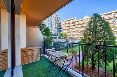 a balcony with a table and chairs on it at Magnifique studio avec terrasse au cœur de Cannes in Cannes