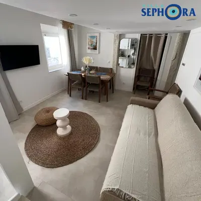 a living room with a couch and a table at VILLA SEPHORA CANNES in Cannes