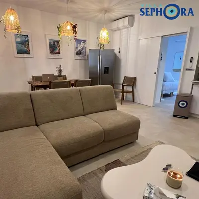 a living room with a couch and a table at VILLA SEPHORA CANNES in Cannes