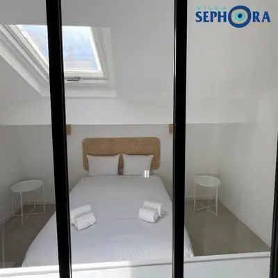 a bedroom with a bed with two towels on it at VILLA SEPHORA CANNES in Cannes