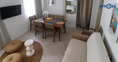 a living room with a table and a couch at VILLA SEPHORA CANNES in Cannes