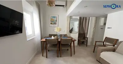 a living room with a table and chairs and a couch at VILLA SEPHORA CANNES in Cannes