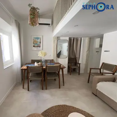 a living room with a table and a couch at VILLA SEPHORA CANNES in Cannes