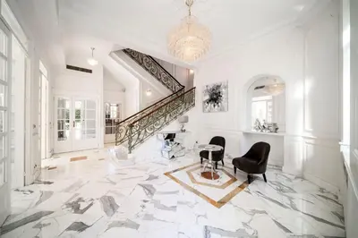a large white room with a staircase and chairs at REF 1981 - Cannes Center - Particular town house for rent in Cannes