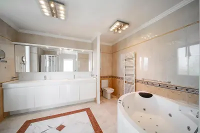 a large bathroom with a tub and a toilet at REF 1981 - Cannes Center - Particular town house for rent in Cannes
