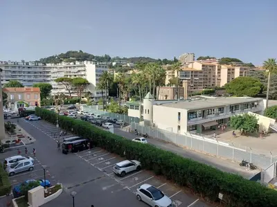 a city with cars parked in a parking lot at Bocca Baie T2 en bord de mer - Axelle Loc Appart in Cannes