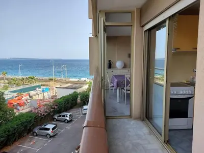 a balcony of a building with a view of the ocean at Bocca Baie T2 en bord de mer - Axelle Loc Appart in Cannes