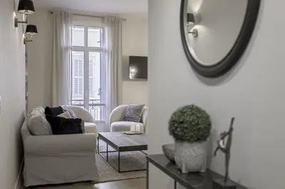a living room with a chair and a mirror at Appartement De Luxe, Meynadier by Halldis in Cannes