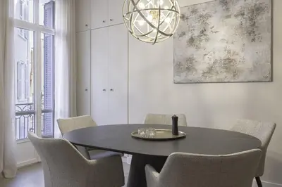 a dining room with a black table and chairs at Appartement De Luxe, Meynadier by Halldis in Cannes