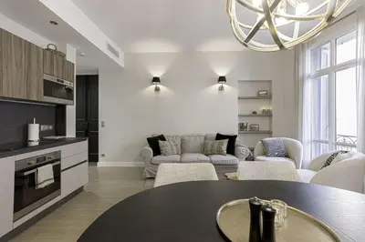 a kitchen and living room with a table and chairs at Appartement De Luxe, Meynadier by Halldis in Cannes
