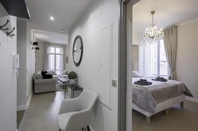 a bedroom with a bed and a living room at Appartement De Luxe, Meynadier by Halldis in Cannes