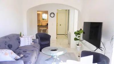 a living room with a couch and a tv at Proche Centre Ville, T4, Exclusivité Congrès - Palmazur Vacances in Cannes