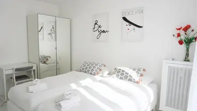 a bedroom with a white bed and a mirror at Proche Centre Ville, T4, Exclusivité Congrès - Palmazur Vacances in Cannes