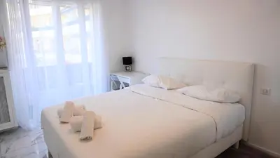 a bedroom with a white bed with two stuffed animals on it at Proche Centre Ville, T4, Exclusivité Congrès - Palmazur Vacances in Cannes