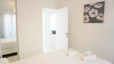 a white room with a mirror and a bed at Proche Centre Ville, T4, Exclusivité Congrès - Palmazur Vacances in Cannes