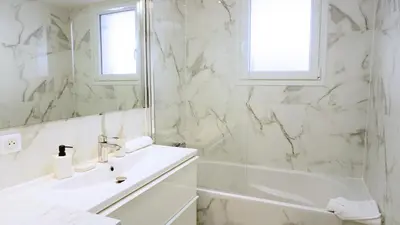 a white bathroom with a sink and a mirror at Proche Centre Ville, T4, Exclusivité Congrès - Palmazur Vacances in Cannes