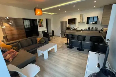 a living room with a couch and a bar at WE CANNES ! Résidence Gallia apartment premium two bedroom in Cannes