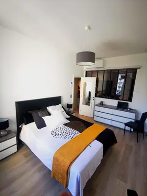 a bedroom with a large bed and a bathroom at WE CANNES ! Résidence Gallia apartment premium two bedroom in Cannes