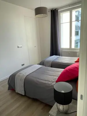 a bedroom with two beds and a window at WE CANNES ! Résidence Gallia apartment premium two bedroom in Cannes