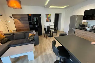 a living room with a couch and a table at WE CANNES ! Résidence Gallia apartment premium two bedroom in Cannes