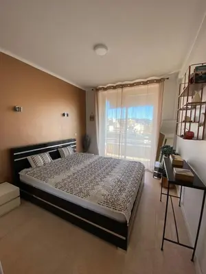 a bedroom with a large bed and a window at 3 Pièces Vue mer & Iles de Lérins in Cannes