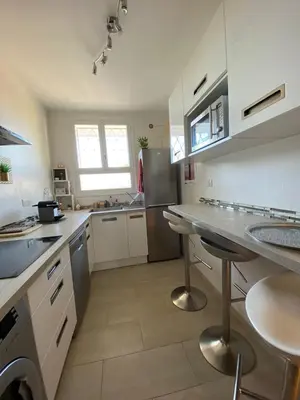 a kitchen with a sink and a refrigerator at 3 Pièces Vue mer & Iles de Lérins in Cannes
