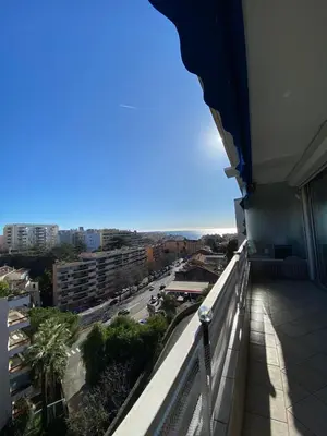 a balcony of a building with a view of a street at 3 Pièces Vue mer & Iles de Lérins in Cannes