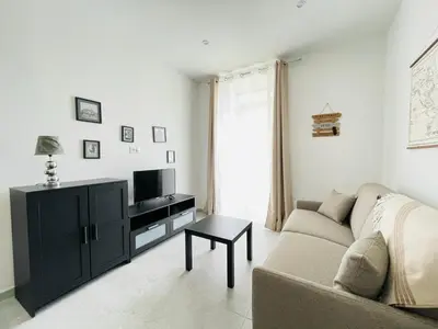 a living room with a couch and a tv at NEGRIN in Cannes