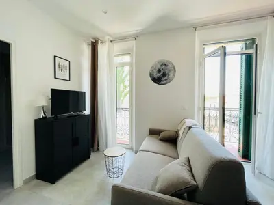 a living room with a couch and a television at NEGRIN in Cannes
