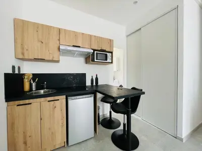 a kitchen with a black counter top and a sink at NEGRIN in Cannes