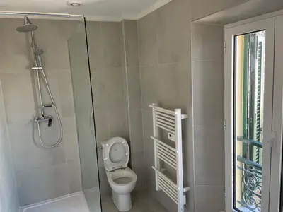 a bathroom with a toilet and a glass shower at NEGRIN in Cannes