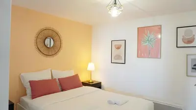 a bedroom with a white bed and some pictures at Proche Palais Des Festivals,Croisette - Hyper centre - Palmazur Vacances in Cannes