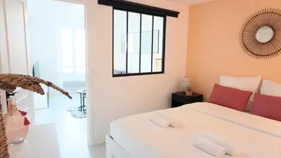 a bedroom with a bed and a mirror on the wall at Proche Palais Des Festivals,Croisette - Hyper centre - Palmazur Vacances in Cannes