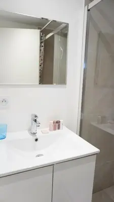 a white bathroom with a sink and a shower at Proche Palais Des Festivals,Croisette - Hyper centre - Palmazur Vacances in Cannes