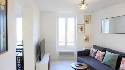 a living room with a couch and a tv at Proche Palais Des Festivals,Croisette - Hyper centre - Palmazur Vacances in Cannes