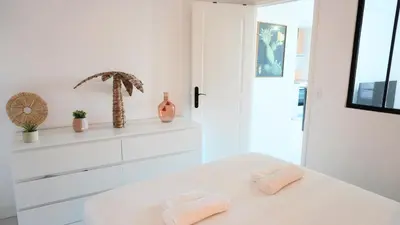 a white bedroom with two towels on a bed at Proche Palais Des Festivals,Croisette - Hyper centre - Palmazur Vacances in Cannes