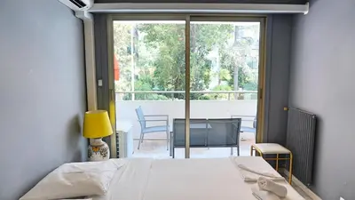 a bedroom with a bed and a view of a balcony at Proche Croisette, T2 avec terrasse, By Palmazur in Cannes