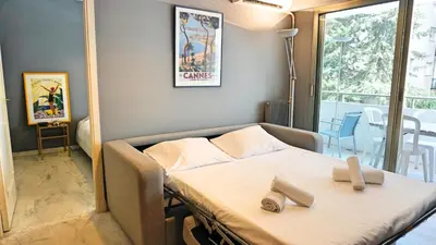a bedroom with a bed with two pairs of shoes on it at Proche Croisette, T2 avec terrasse, By Palmazur in Cannes