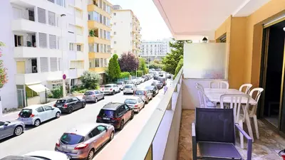 a balcony with cars parked on a city street at Proche Croisette, T2 avec terrasse, By Palmazur in Cannes