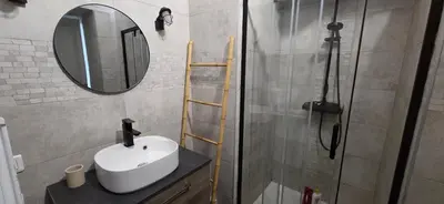 a bathroom with a sink and a shower with a mirror at Charmant studio in Cannes