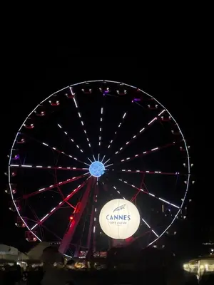 a ferris wheel at night with lights on it at Charmant studio in Cannes