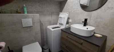 a bathroom with a white sink and a mirror at Charmant studio in Cannes